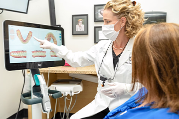 dentist showing patient teeth