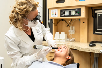 dentist looking at patients teeth