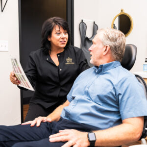 dentist talking with patient in dental chair